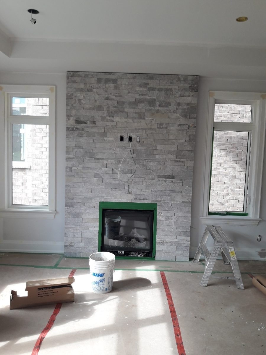 Fireplace clad in grey stacked stone tile